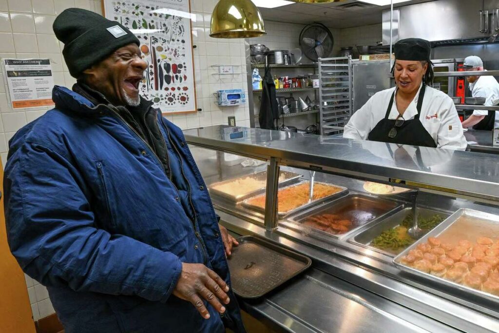 Balinda serving smiling walter